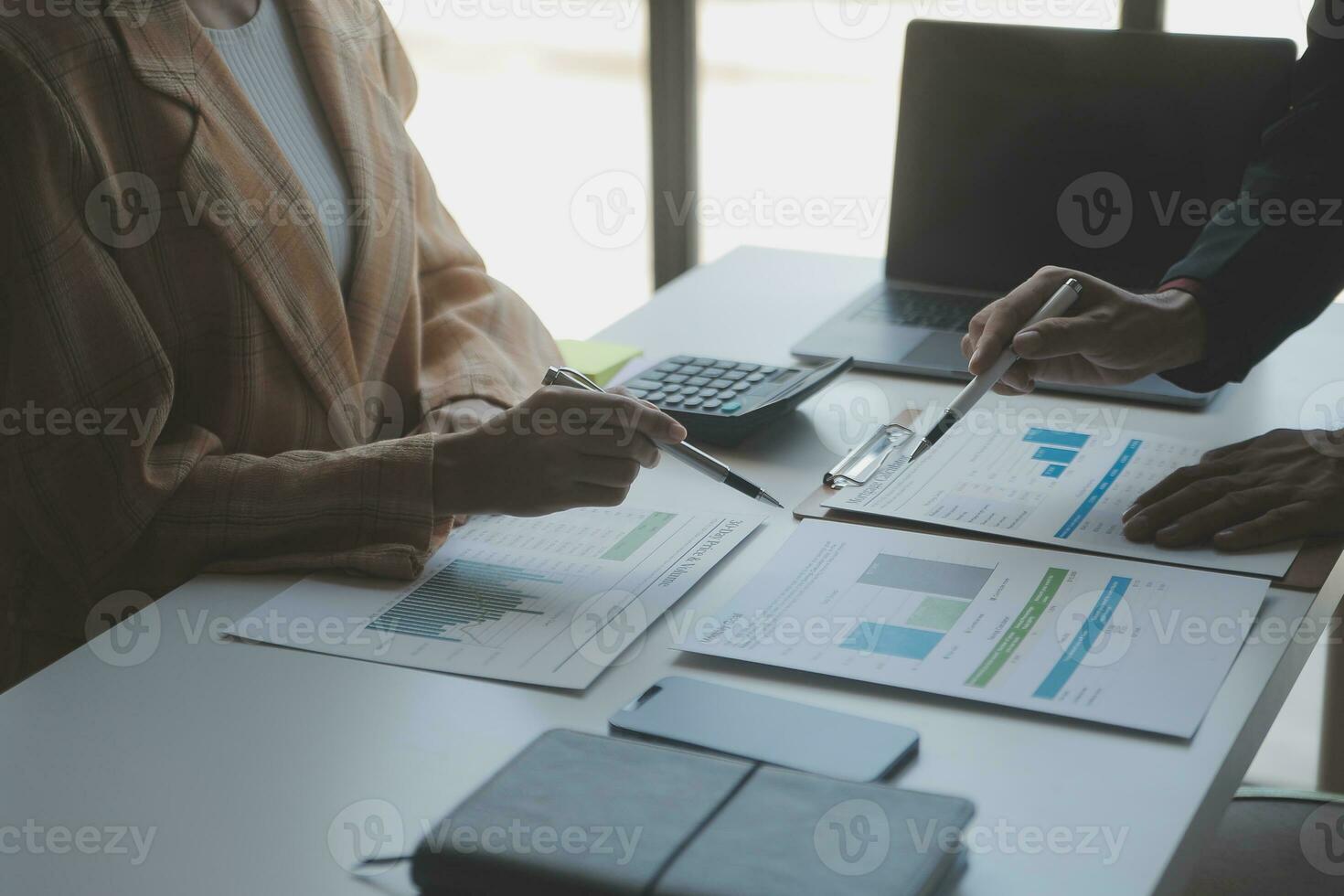Asian Business woman using calculator and laptop for doing math finance on an office desk, tax, report, accounting, statistics, and analytical research concept photo