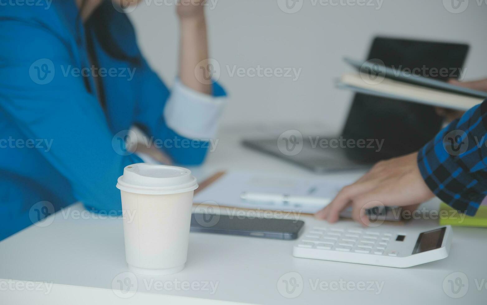 Asian Business woman using calculator and laptop for doing math finance on an office desk, tax, report, accounting, statistics, and analytical research concept photo