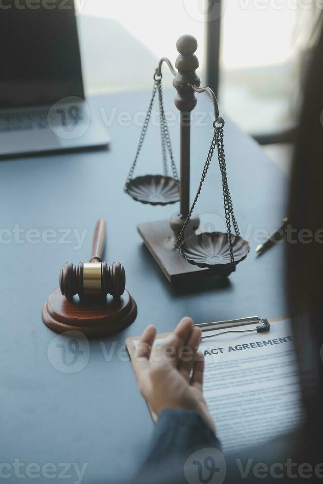 Male lawyer working with contract papers and wooden gavel on tabel in courtroom. justice and law ,attorney, court judge, concept. photo