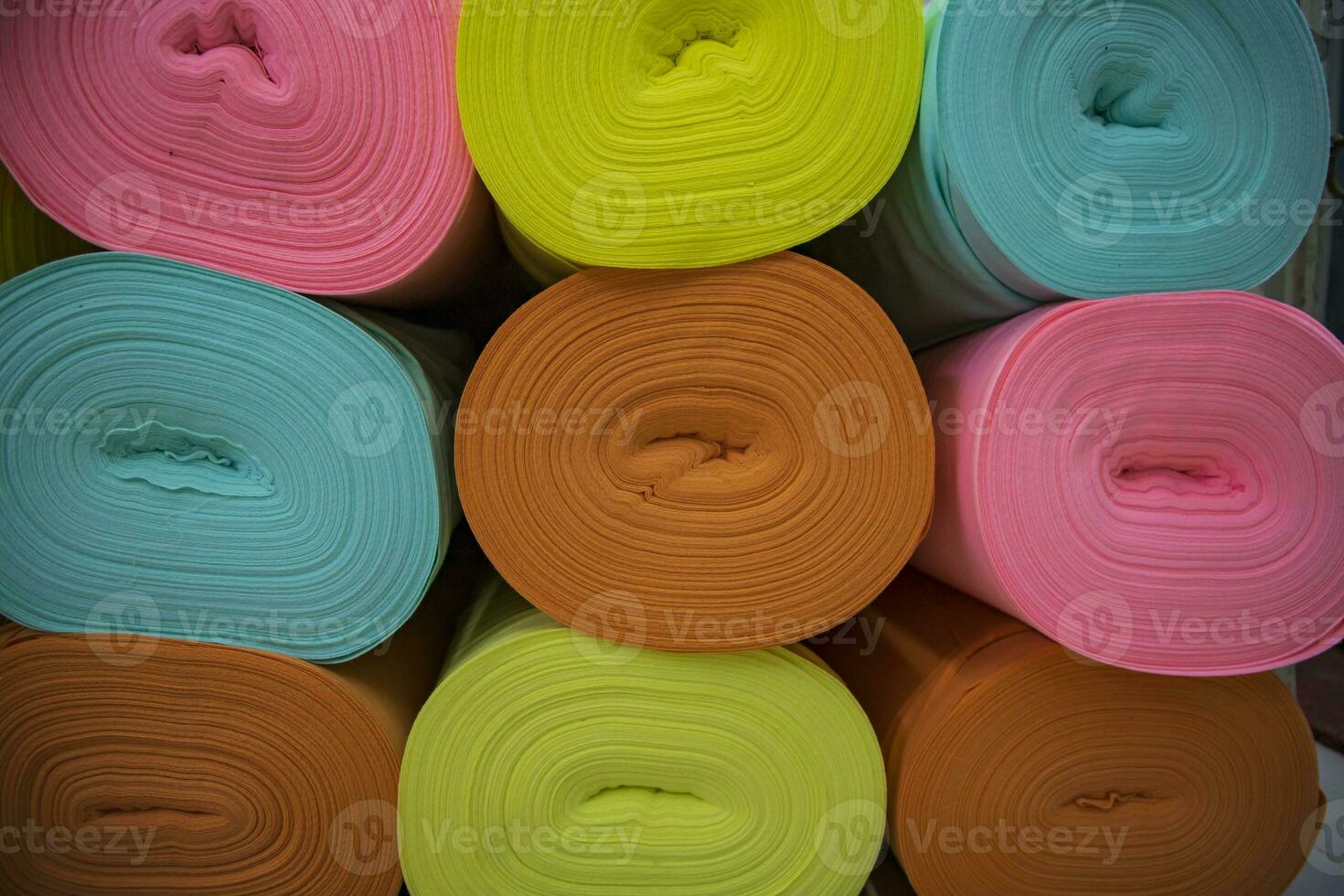 Artistic variety of shade tone colors Textile Fabrics rolls stacked pattern texture photo