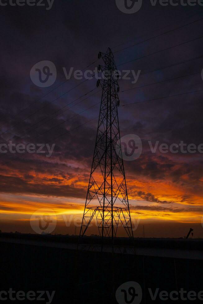 High voltage power line tower with beautiful sky at sunset, stock photo