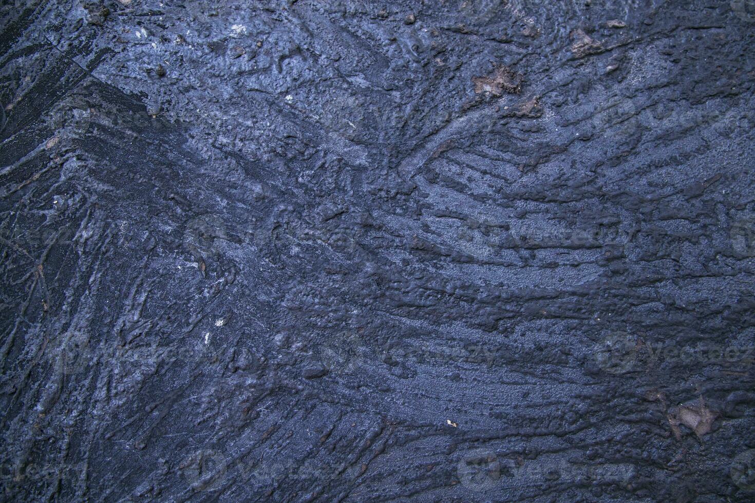 Old metal surface covered black ash abstract background texture photo