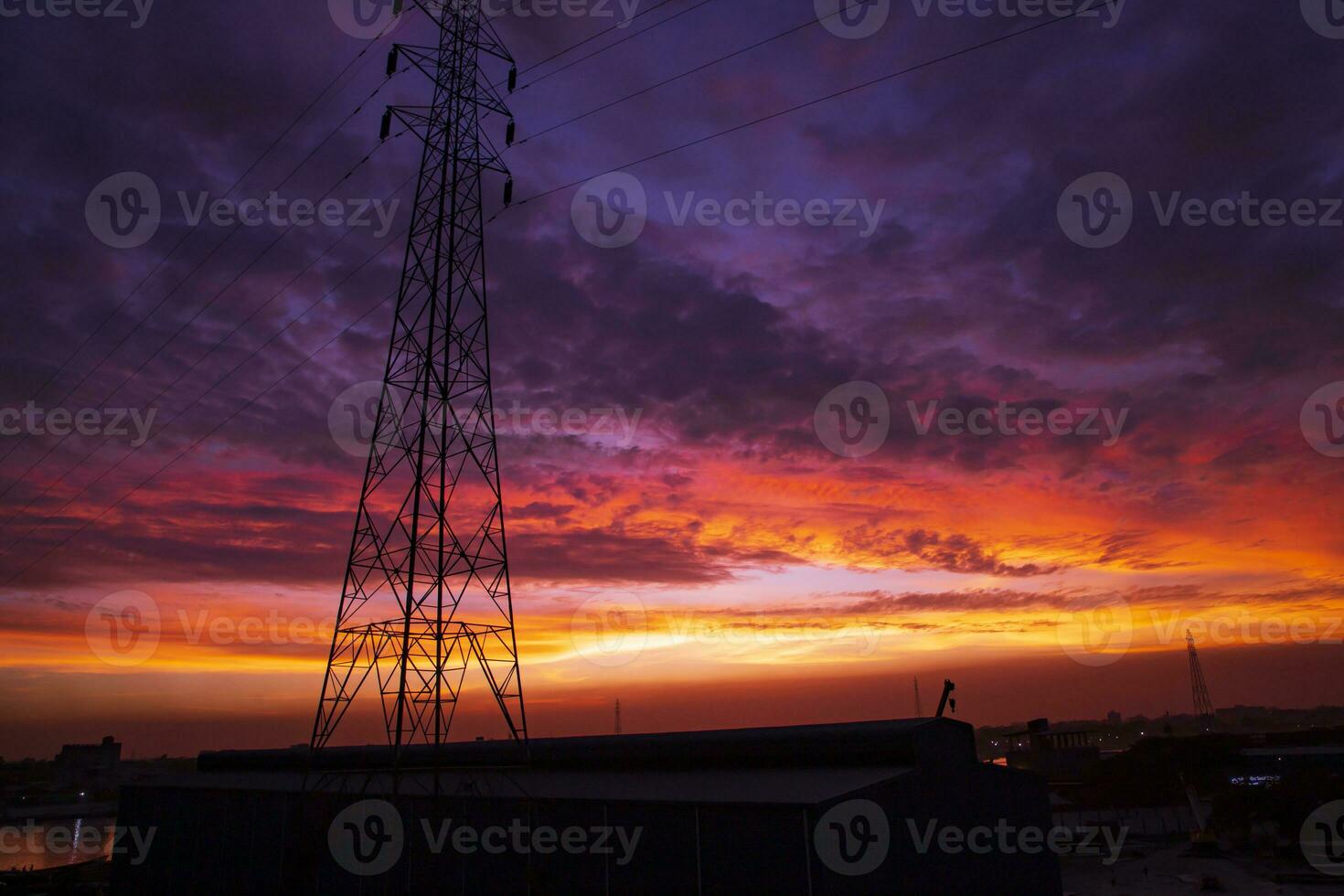 High voltage power line tower with beautiful sky at sunset, stock photo