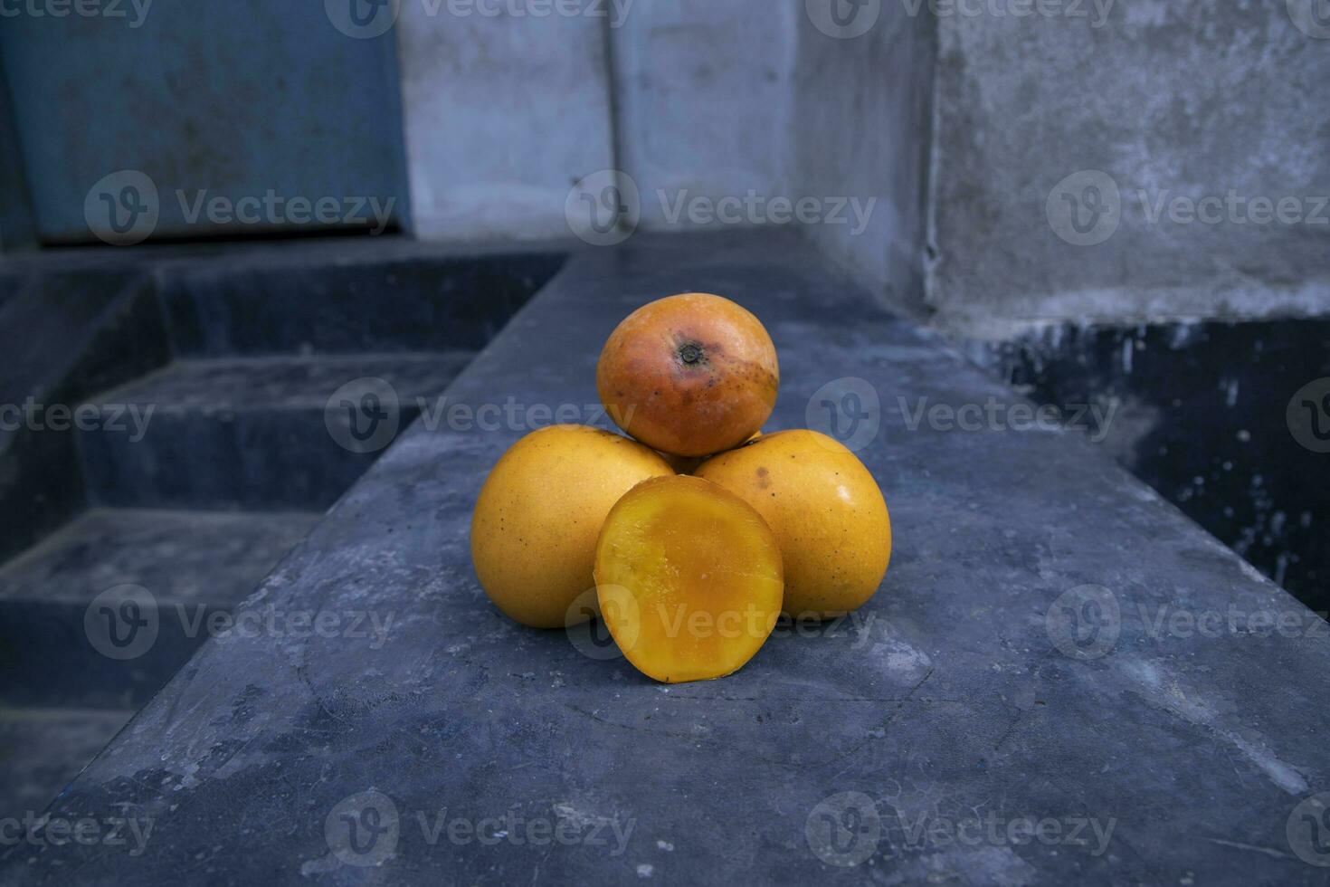 Ripe yellow mango fruit on a black background. Tropical fruit. photo