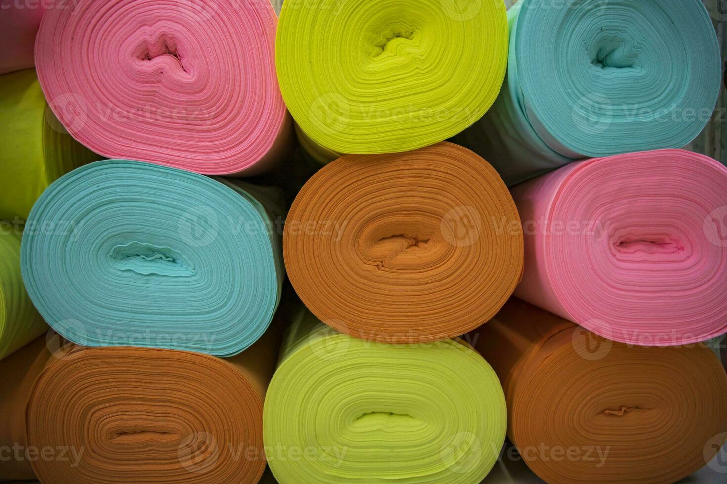 Artistic variety of shade tone colors Textile Fabrics rolls stacked pattern texture photo