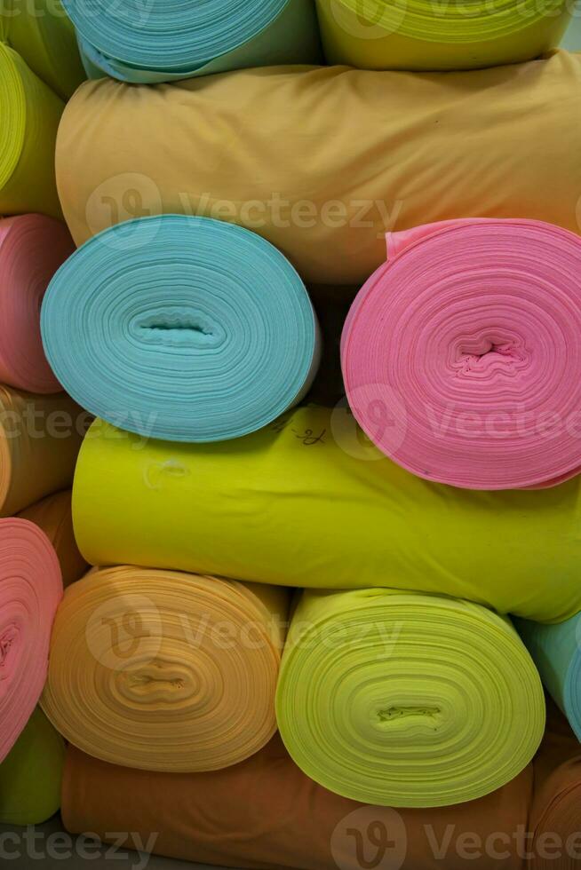 Artistic variety of shade tone colors Textile Fabrics rolls stacked pattern texture photo