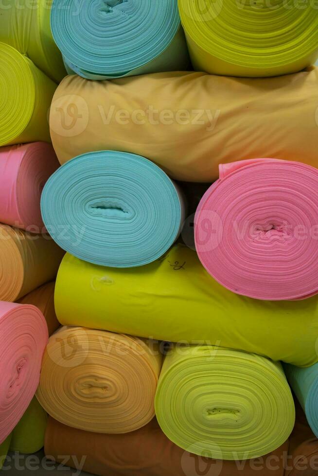 Artistic variety of shade tone colors Textile Fabrics rolls stacked pattern texture photo