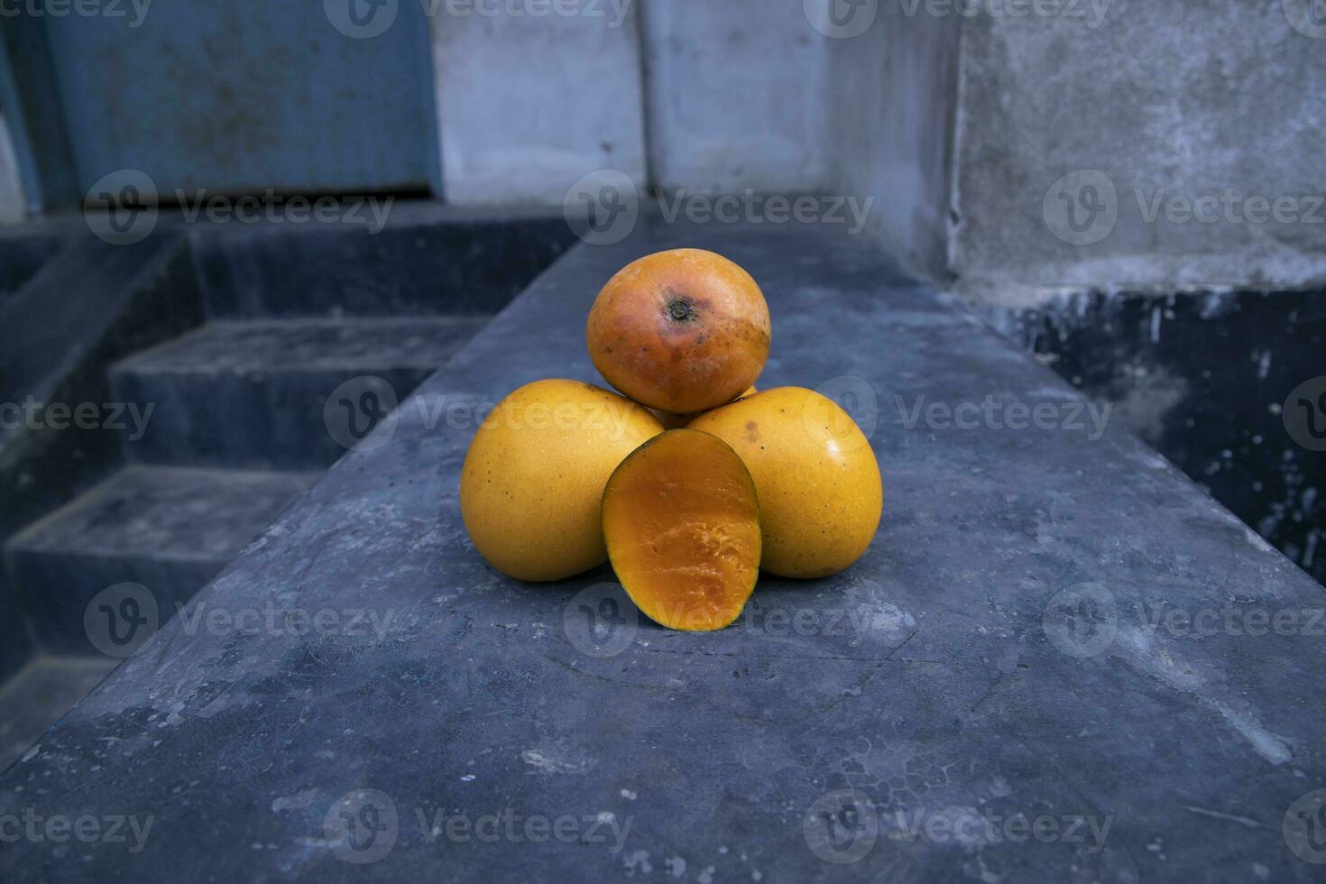 Ripe yellow mango fruit on a black background. Tropical fruit. photo