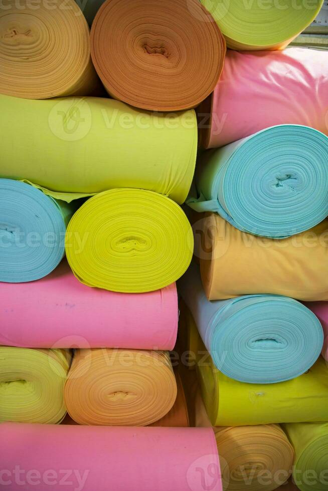 Artistic variety of shade tone colors Textile Fabrics rolls stacked pattern texture photo