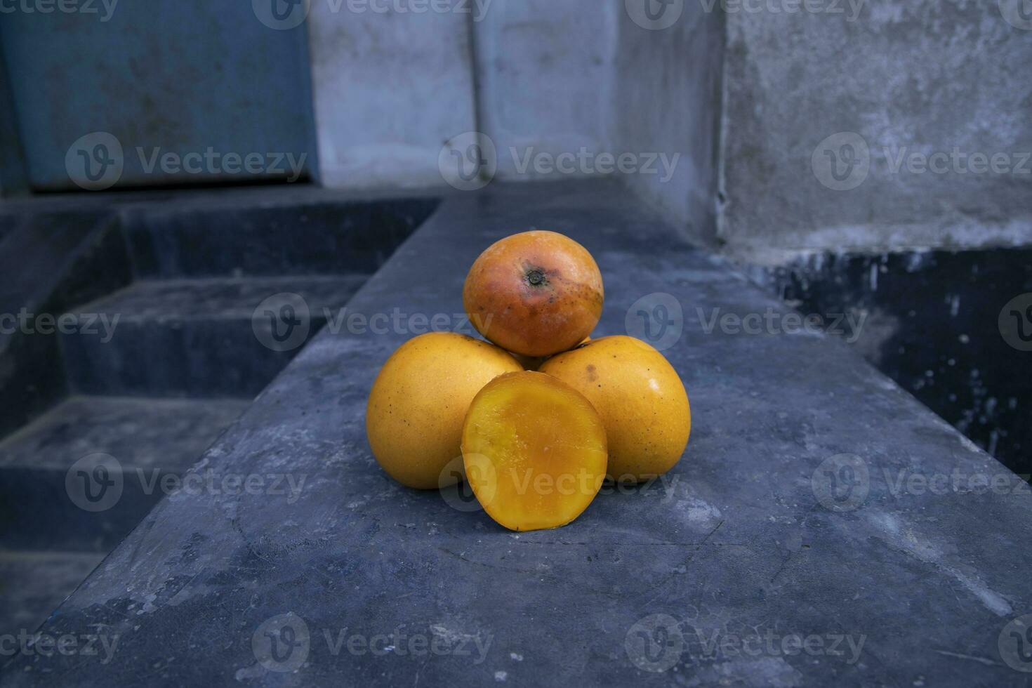 Ripe yellow mango fruit on a black background. Tropical fruit. photo