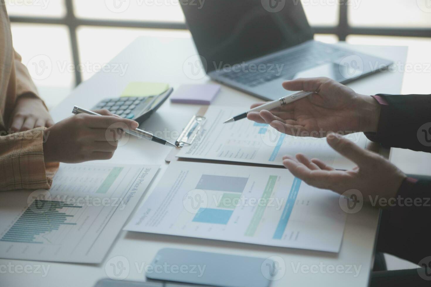 Asian Business woman using calculator and laptop for doing math finance on an office desk, tax, report, accounting, statistics, and analytical research concept photo