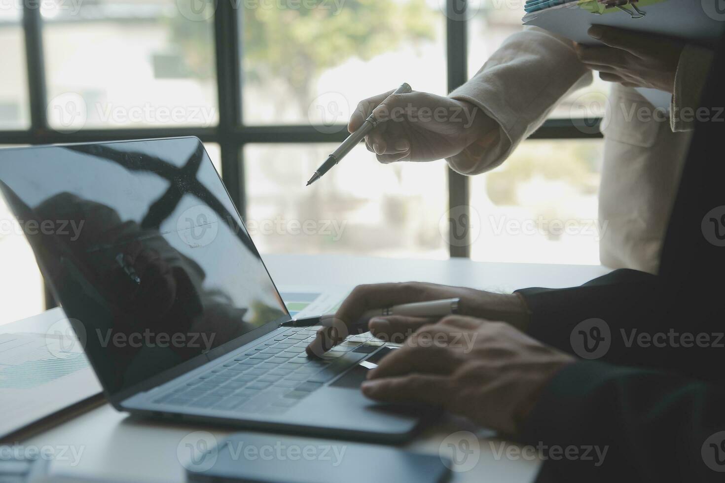 Asian Business woman using calculator and laptop for doing math finance on an office desk, tax, report, accounting, statistics, and analytical research concept photo