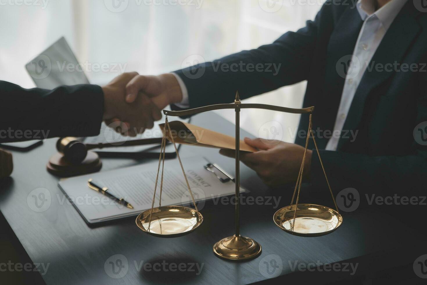 Business and lawyers discussing contract papers with brass scale on desk in office. Law, legal services, advice, justice and law concept picture with film grain effect photo