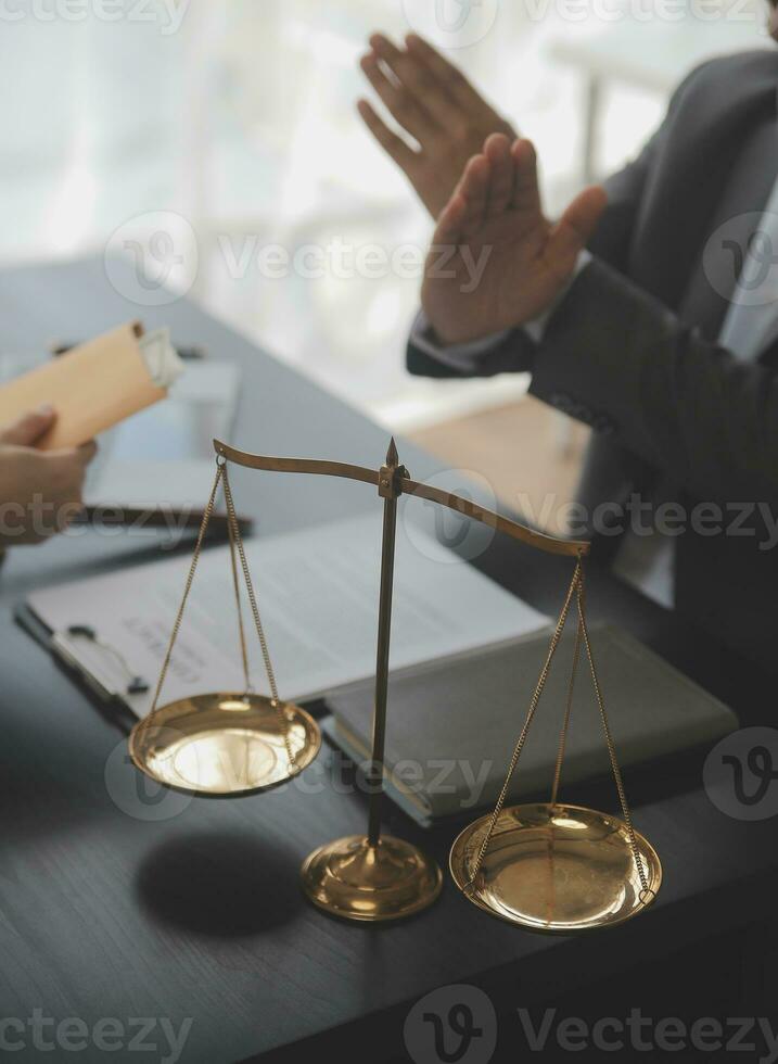 Business and lawyers discussing contract papers with brass scale on desk in office. Law, legal services, advice, justice and law concept picture with film grain effect photo