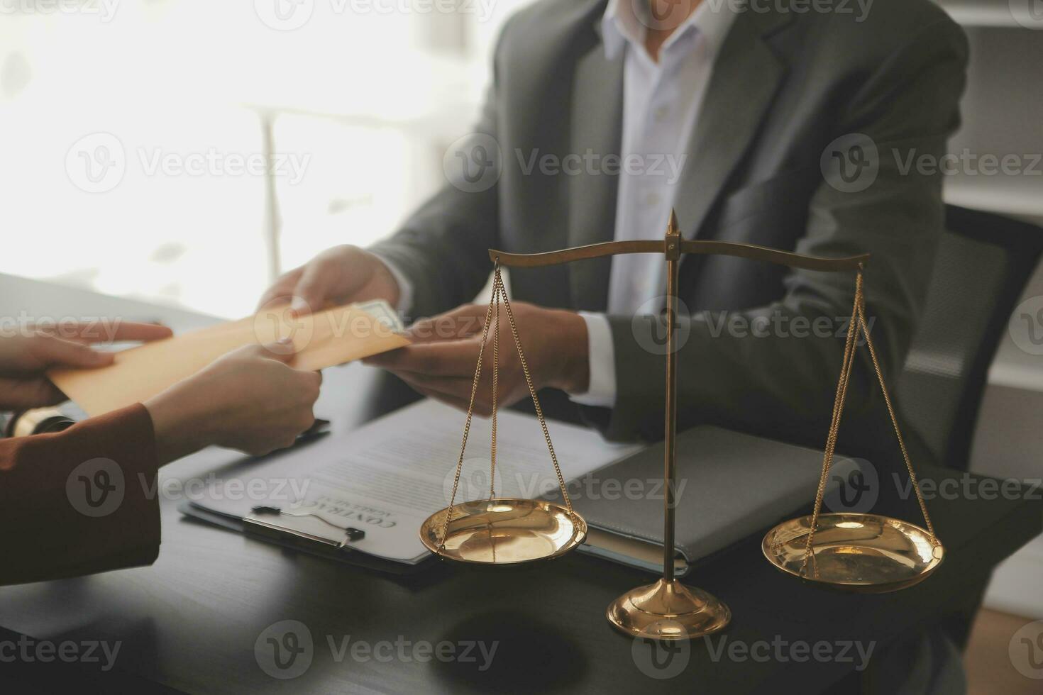 Justice and law concept.Male judge in a courtroom with the gavel, working with, computer and docking keyboard, eyeglasses, on table in morning light photo