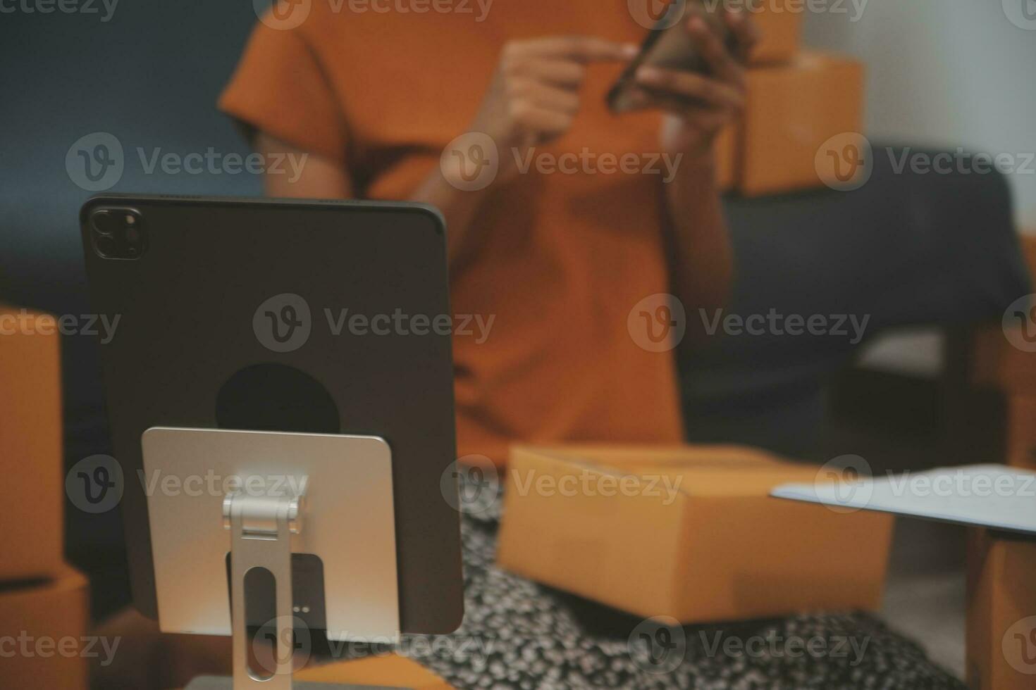 Startup small business entrepreneur or freelance Asian woman using a laptop with box, Young success Asian woman with her hand lift up, online marketing packaging box and delivery, SME concept. photo