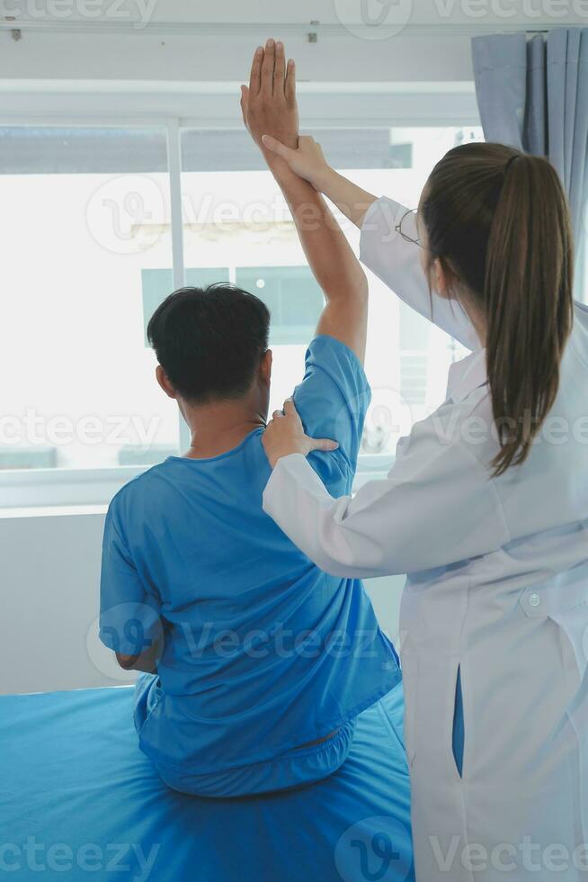 Patient doing some special exercises under supervision in a room photo