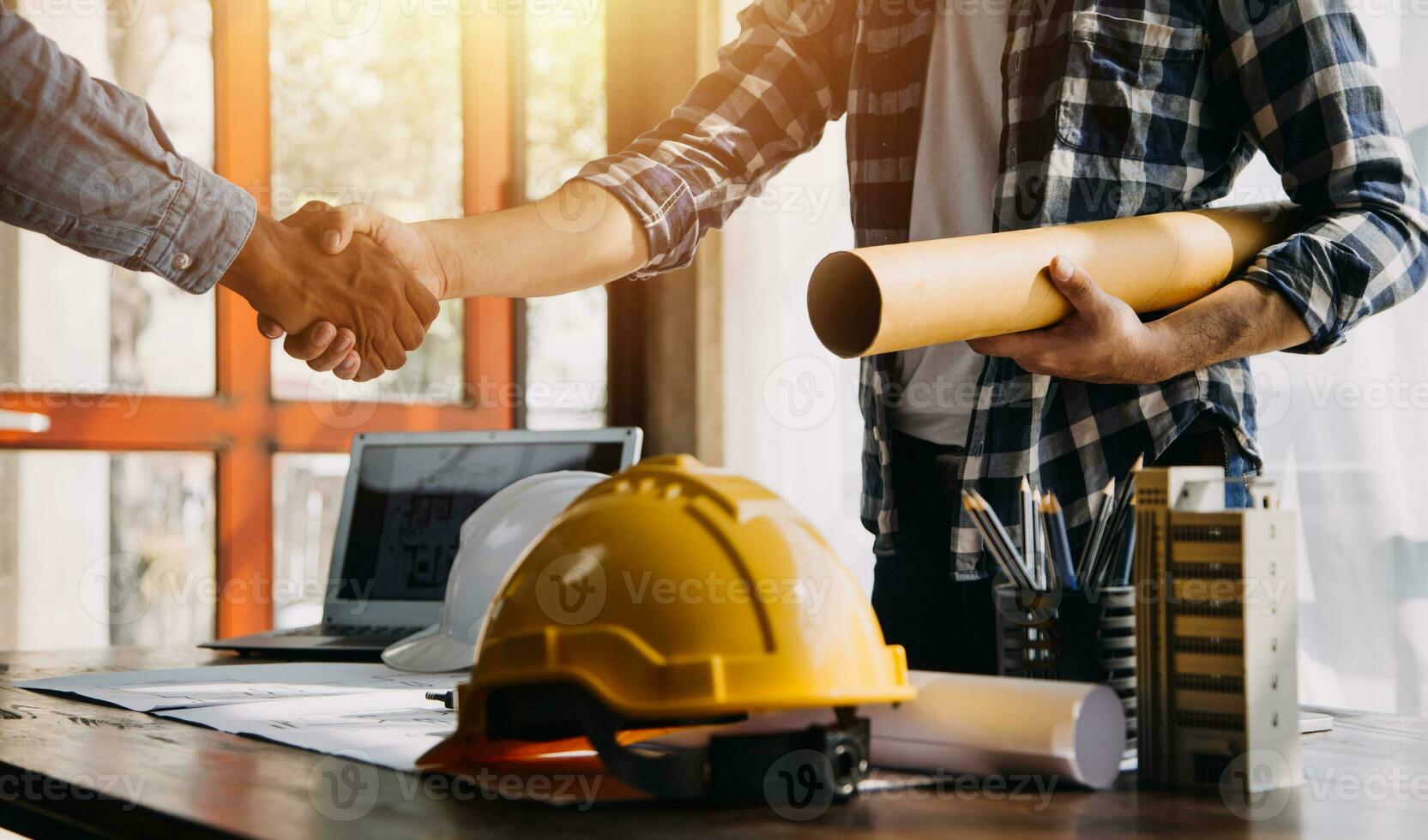 Construction and structure concept of engineer working drawing on blueprint meeting for project working with partner on model building and engineering tools in working site, construction concept. photo