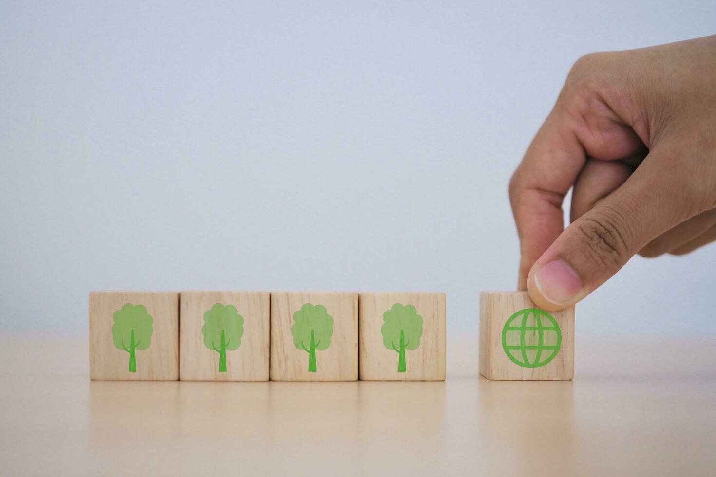 Natural environment Long-term, climate-neutral strategy target to reduce greenhouse gas emissions wooden cube with green icon. photo