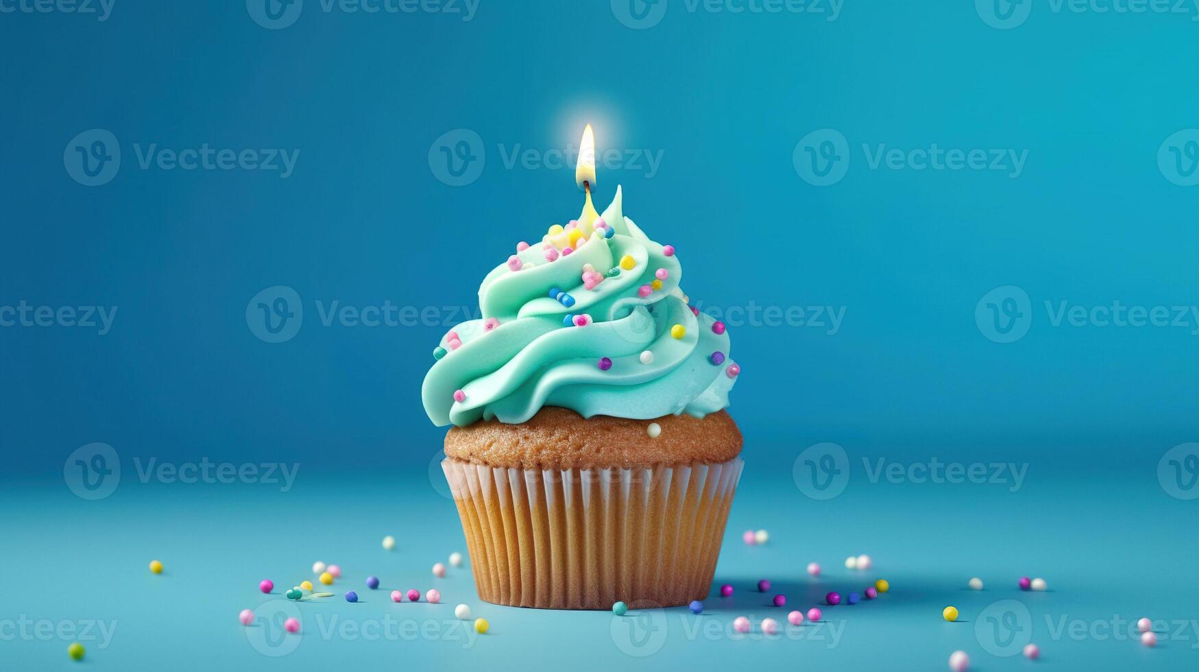 Birthday cupcake with a candle on light blue background with balloons. photo