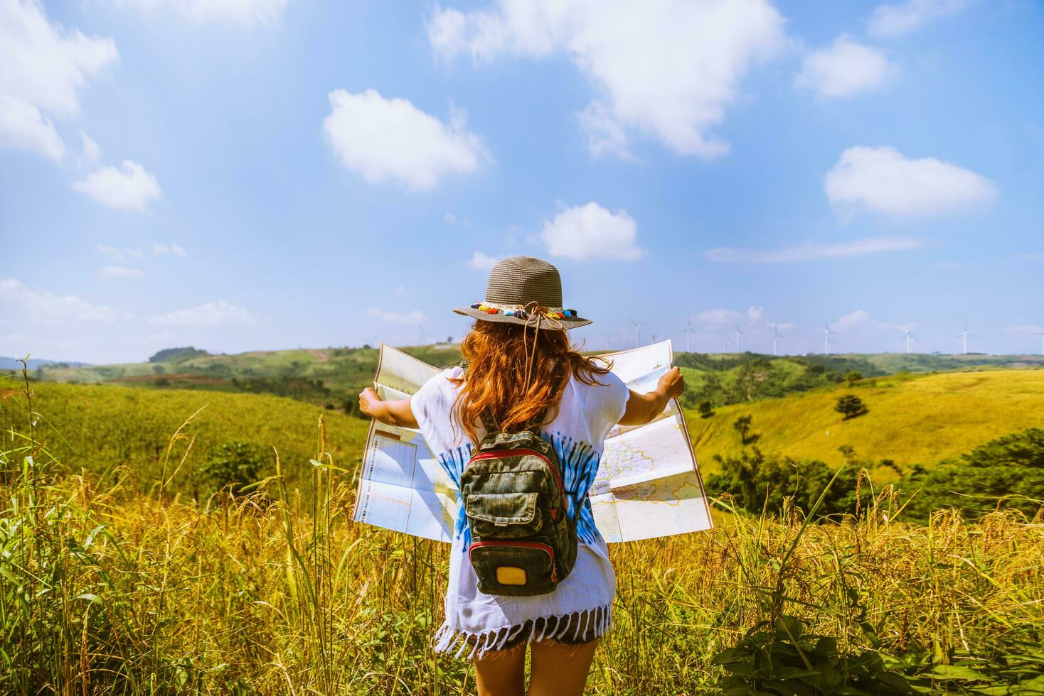 Asian women travel Rice fields green On the mountains in the holiday. happy and enjoying a beautiful nature. Rice fields Golden. Travel with a map of Asian girls. summer photo