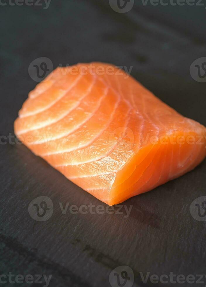 Salmon on the black stone board photo