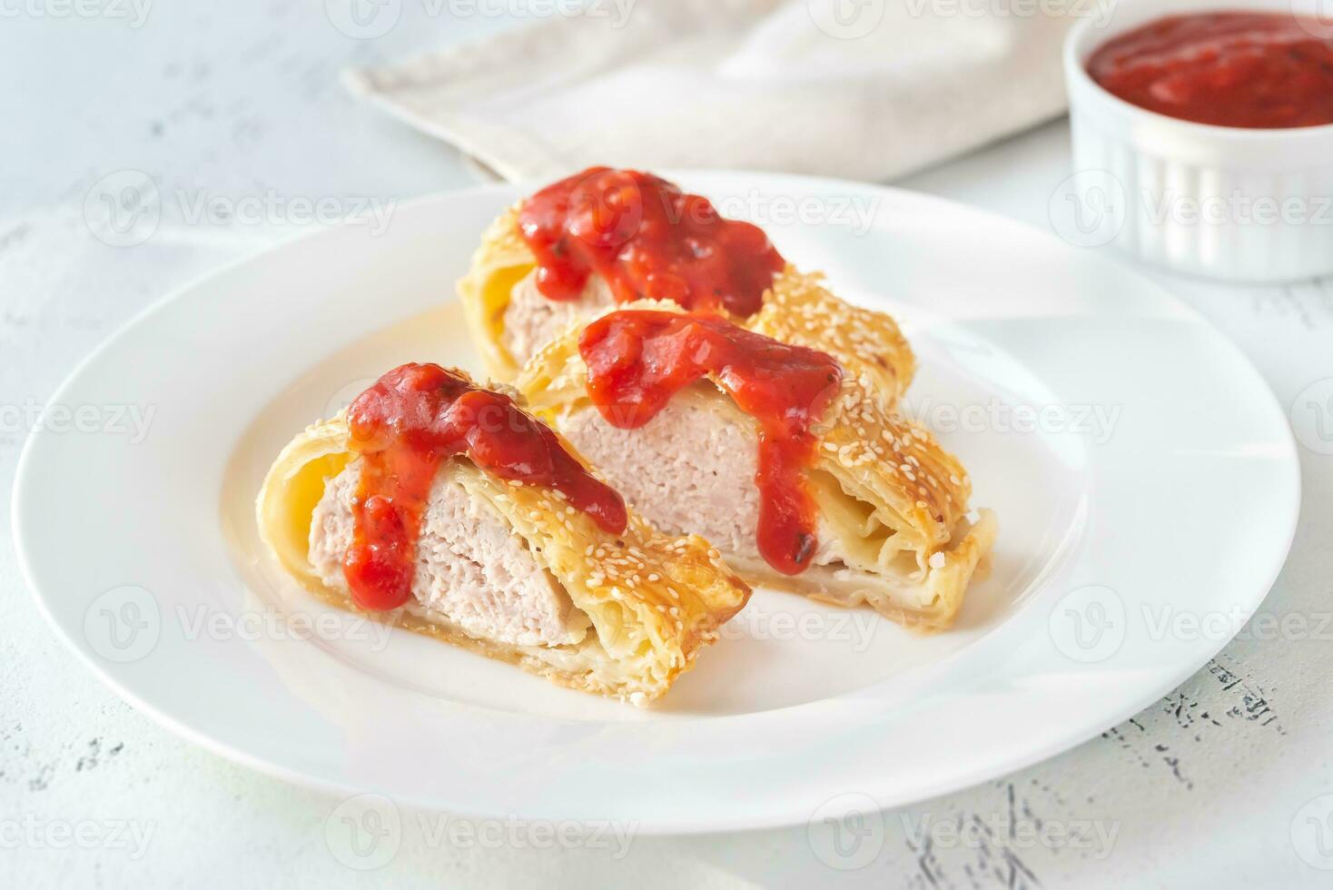 Sausage rolls with tomato sauce photo