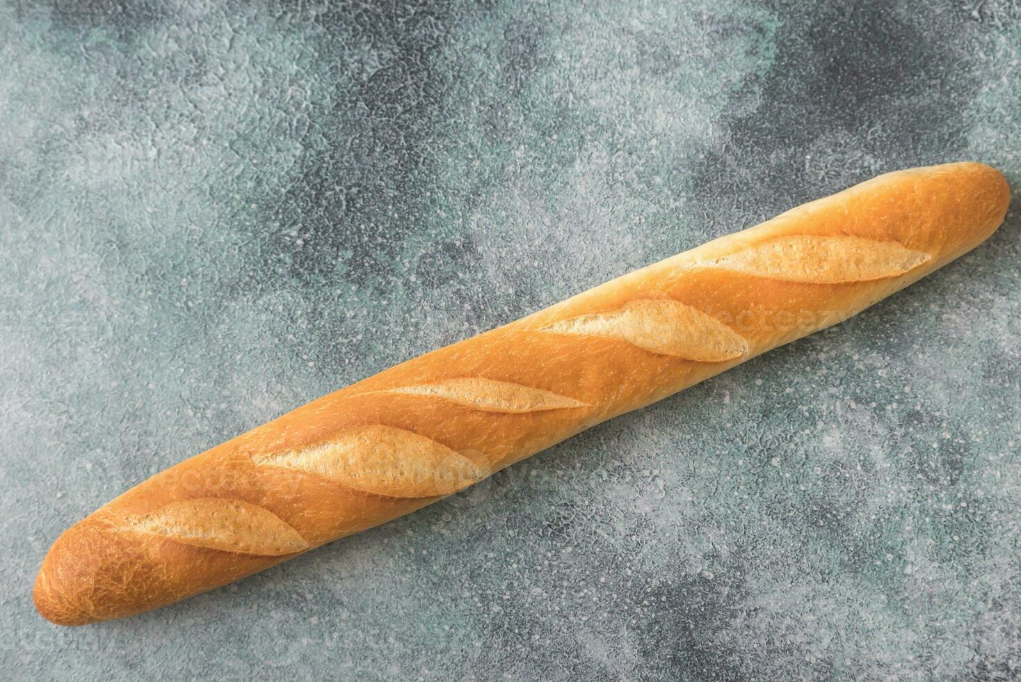 Baguette on the wooden background photo