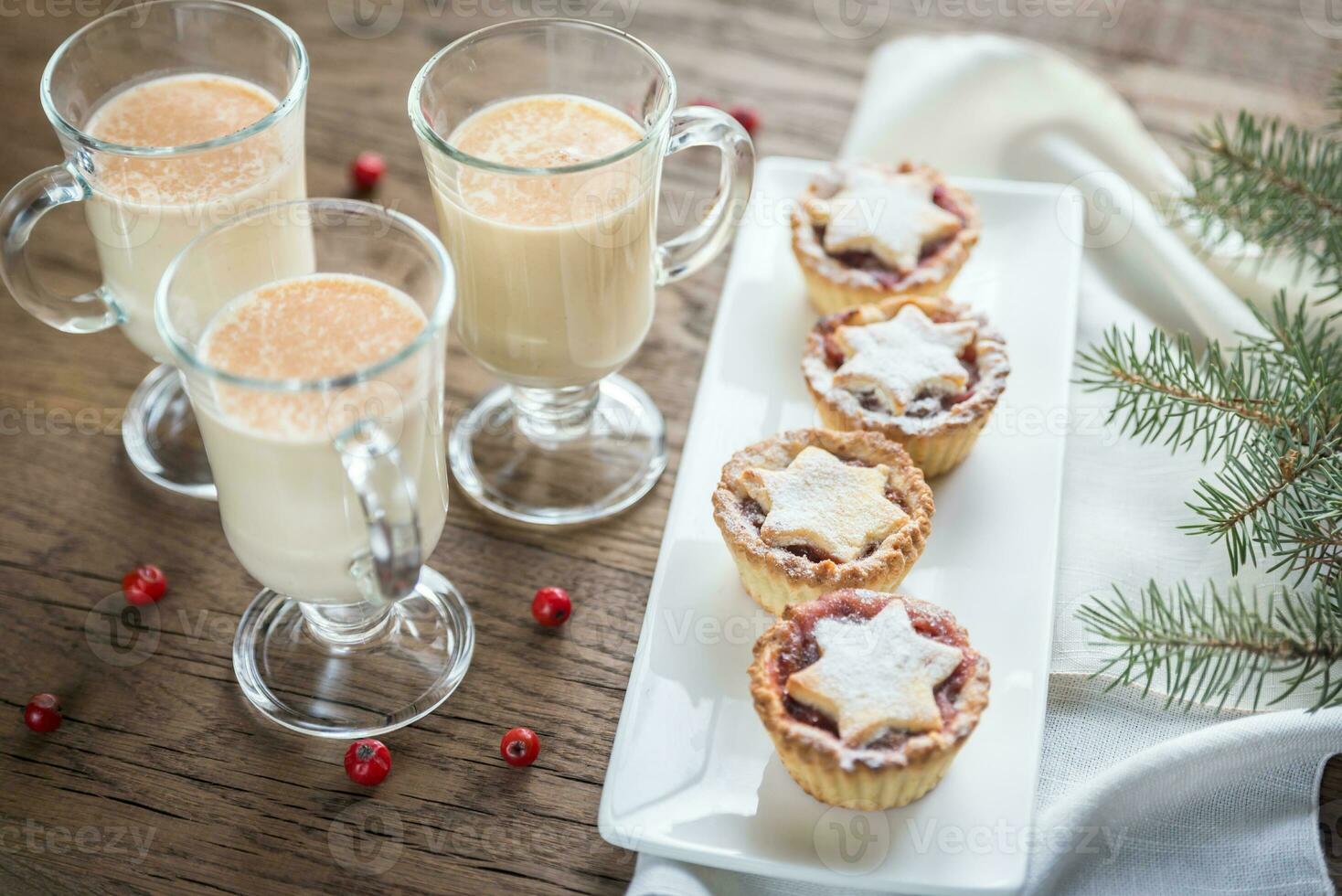 Glasses of eggnog with mince pies photo