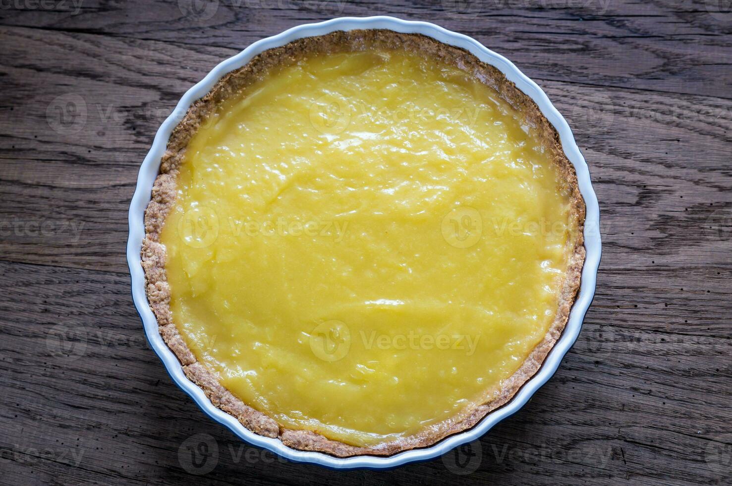 Lemon tart on the wooden background photo