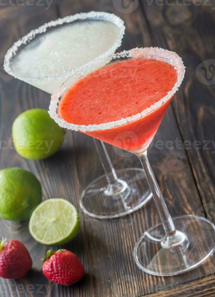 Glasses of lime and strawberry margarita cocktail photo