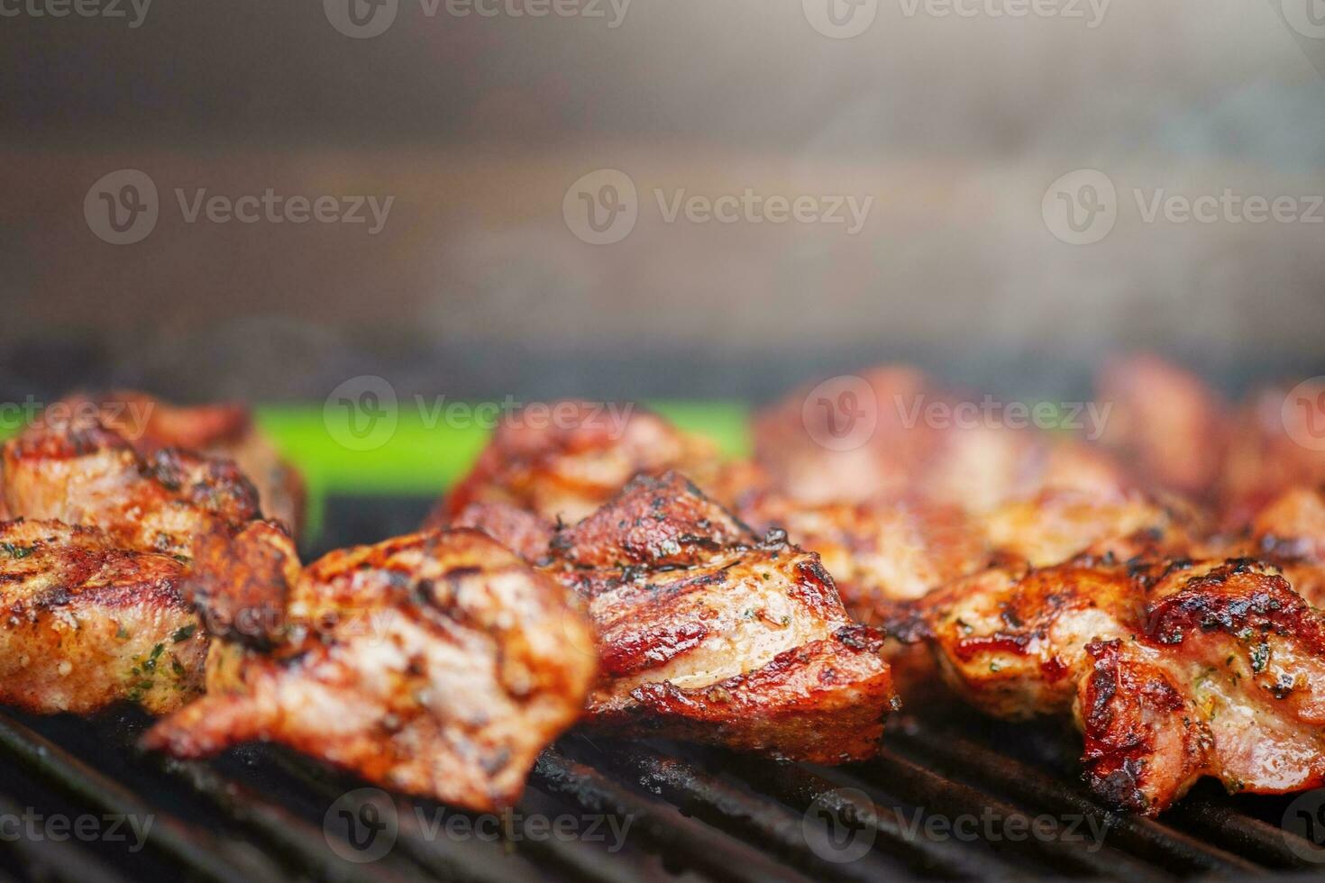 Pork meat is grilled. Cooking kebabs on the grill. photo