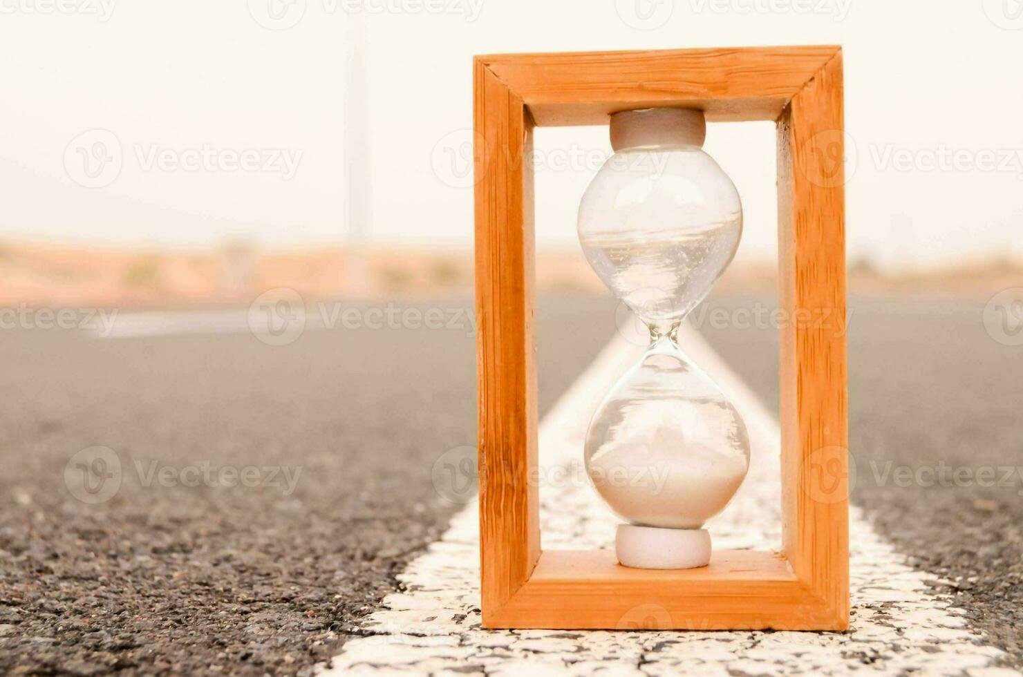 Hourglass on the ground photo