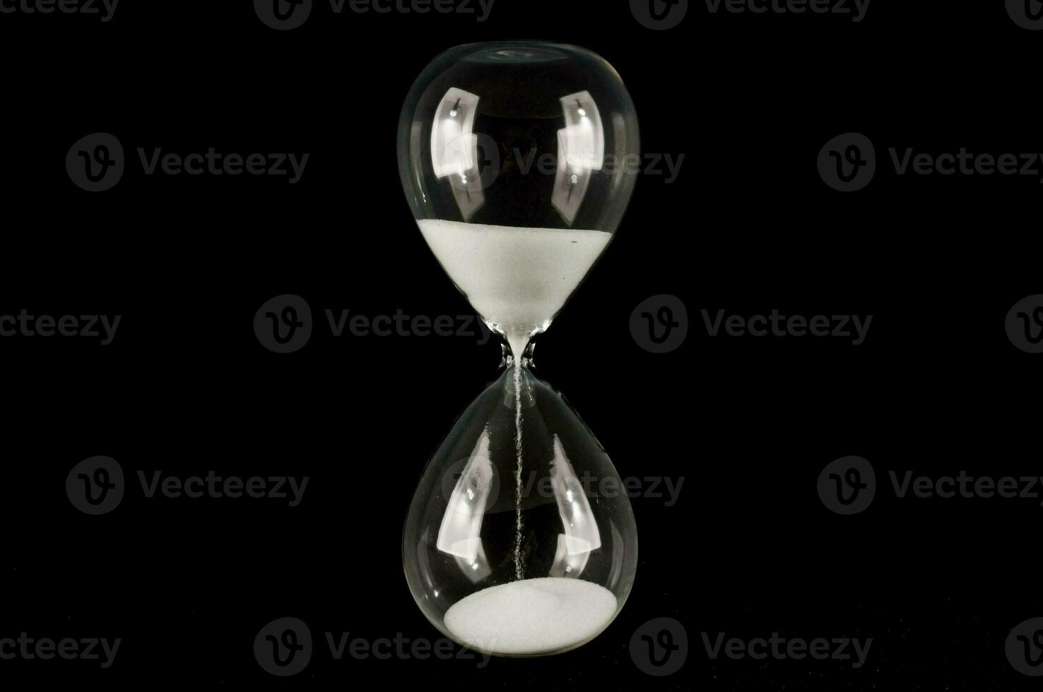 Hourglass on black background photo