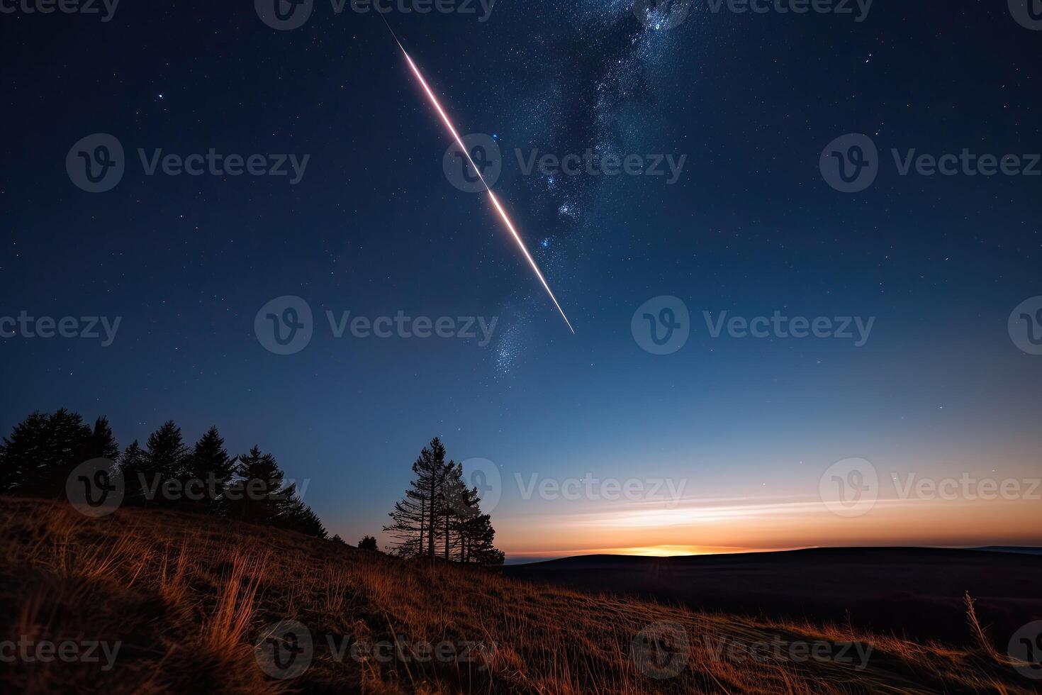 Shooting star streaks across the sky, leaving a trail of light in its wake. photo