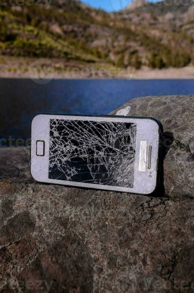 Broken phone on rocks photo