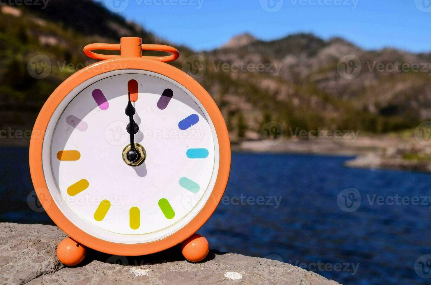 Clock on rocks photo