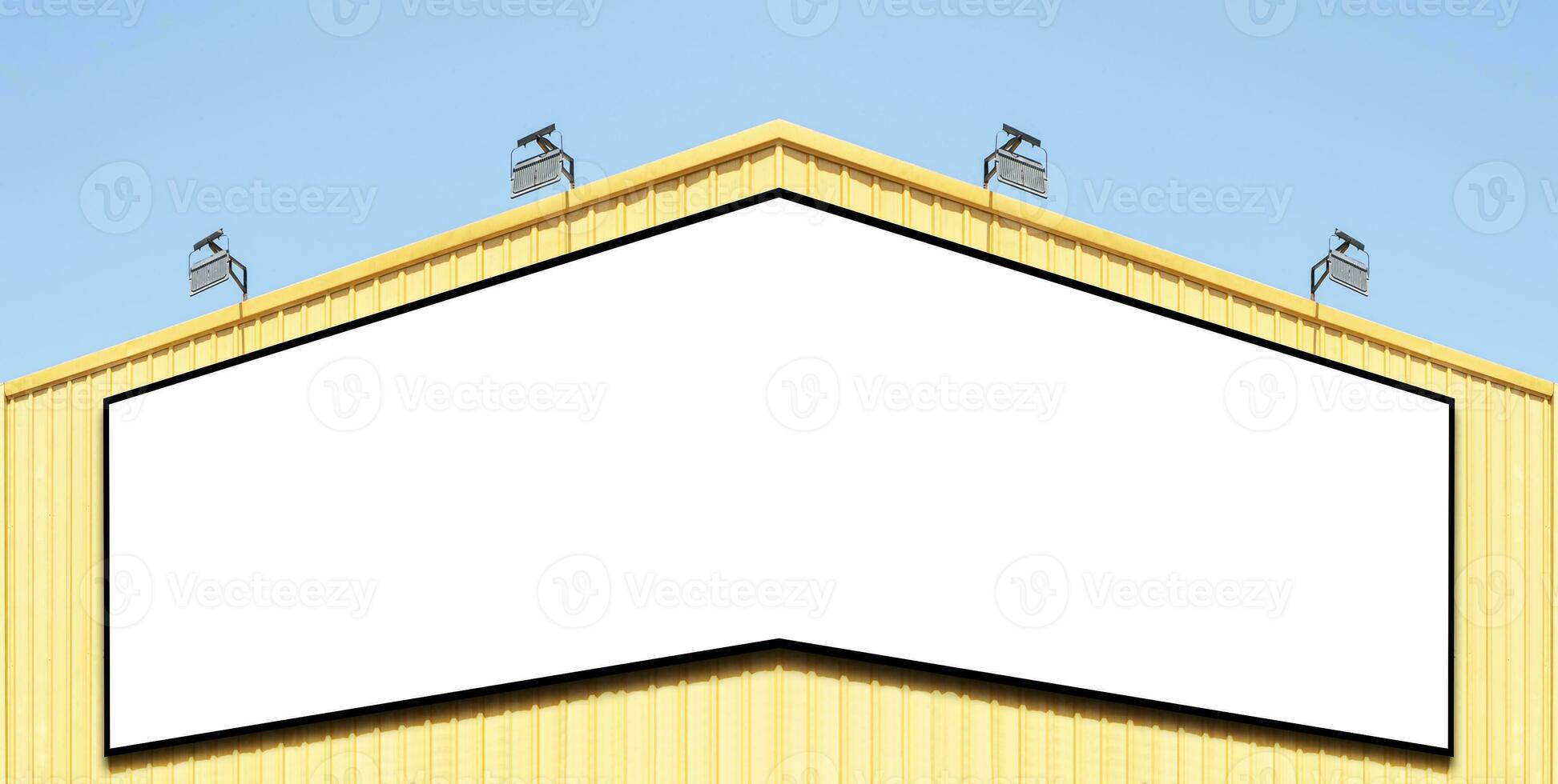 Billboard corner on yellow building with spot light photo