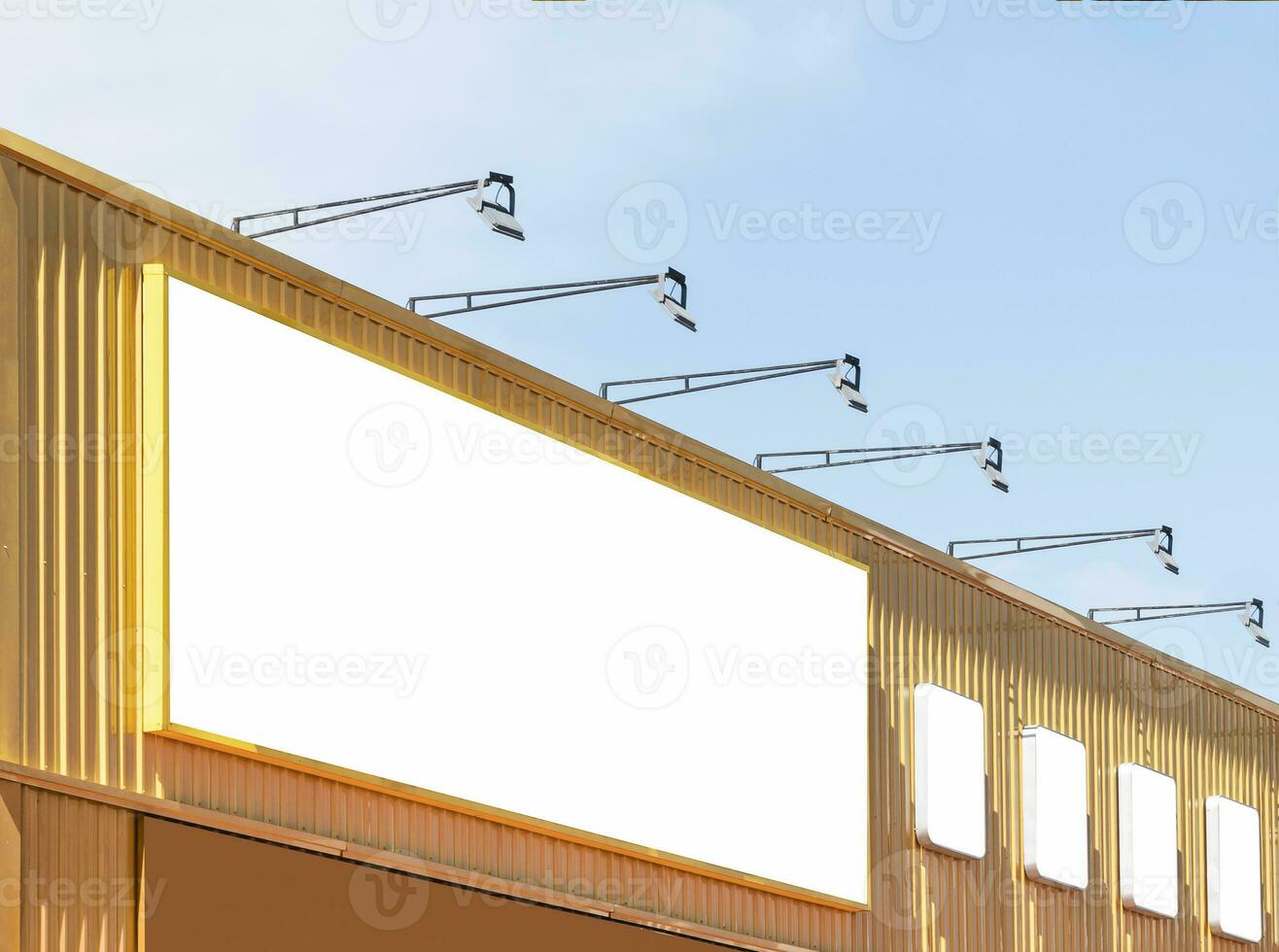 Mock up white background billboard on yellow building with spot light photo