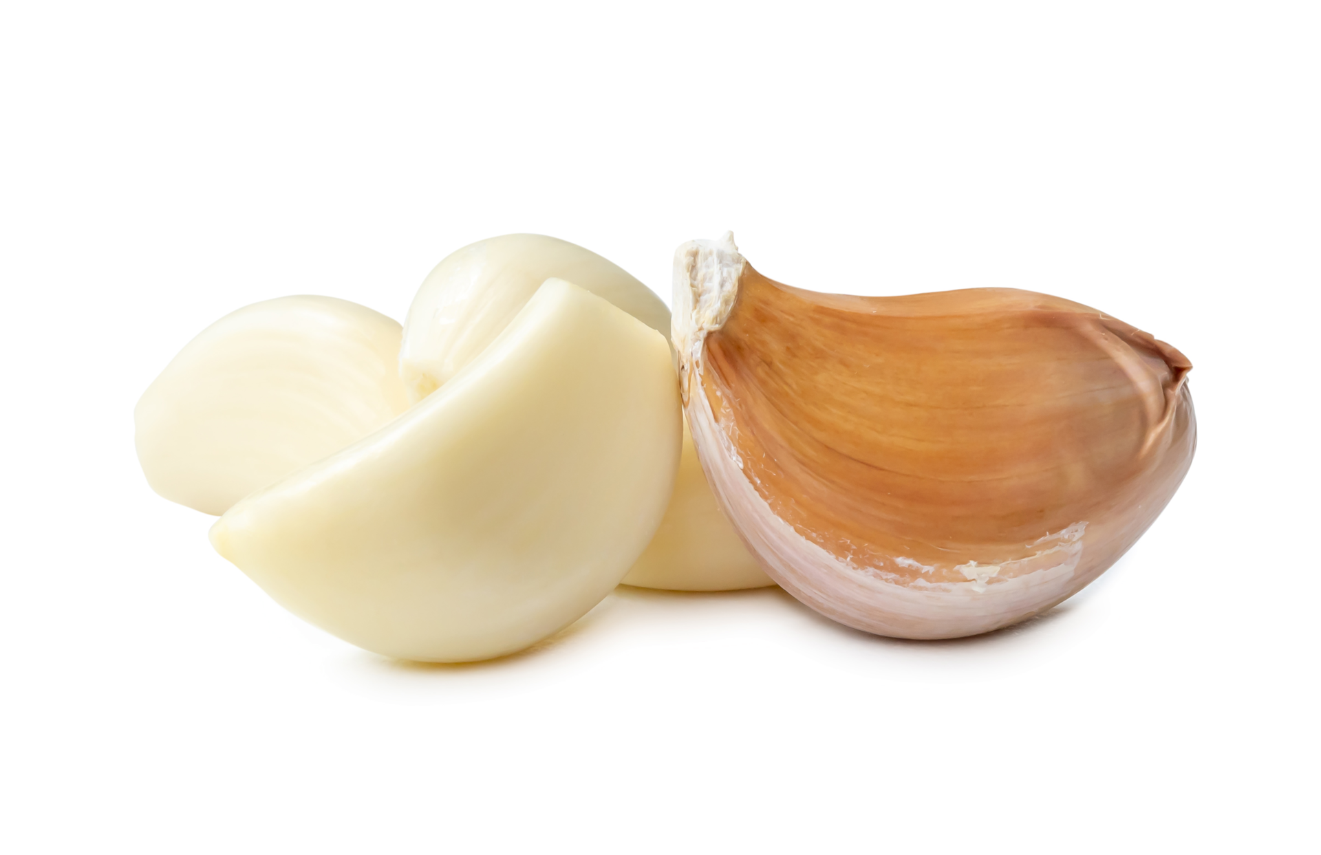 Peeled garlic cloves in stack isolated with clipping path and shadow in