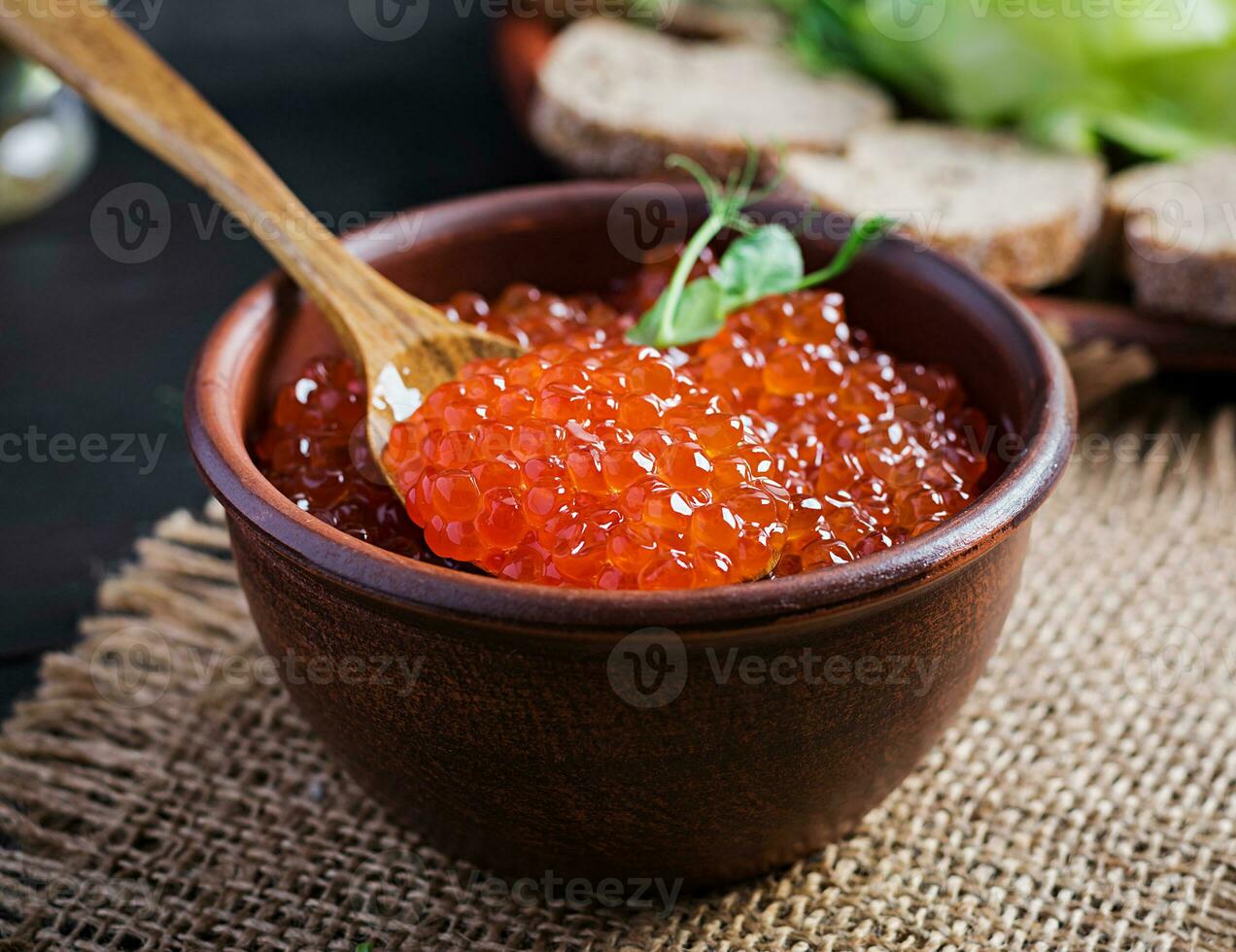 Salmon red caviar in bowl. Delicious food. photo