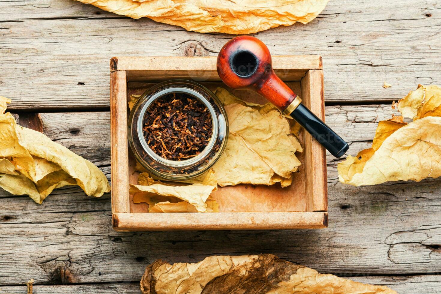 Smoking pipe with tobacco leaves,top view photo