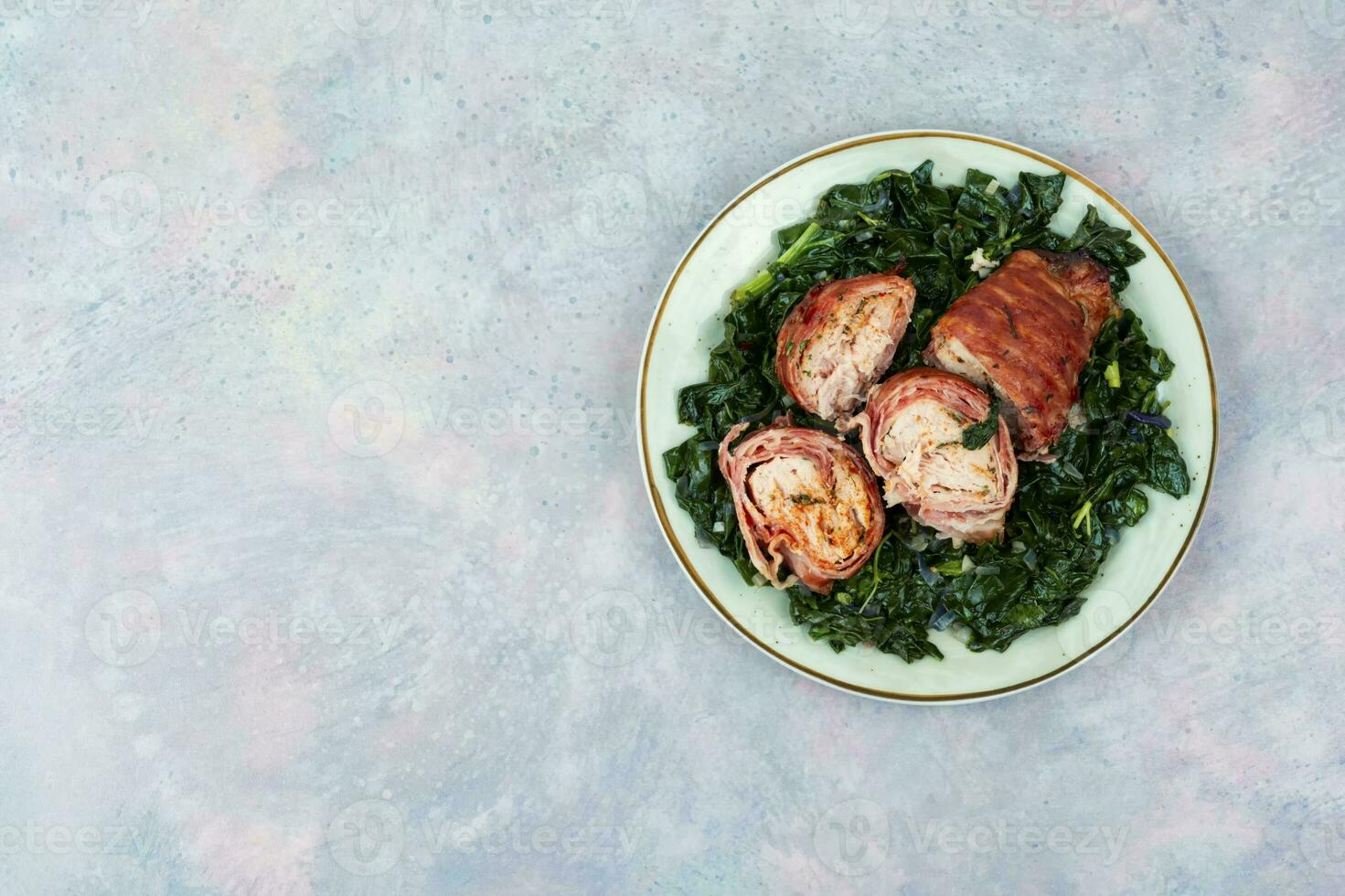 Chicken roll and fried spinach. photo