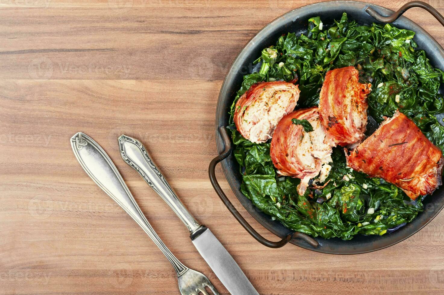 Meat roll and fried spinach. photo