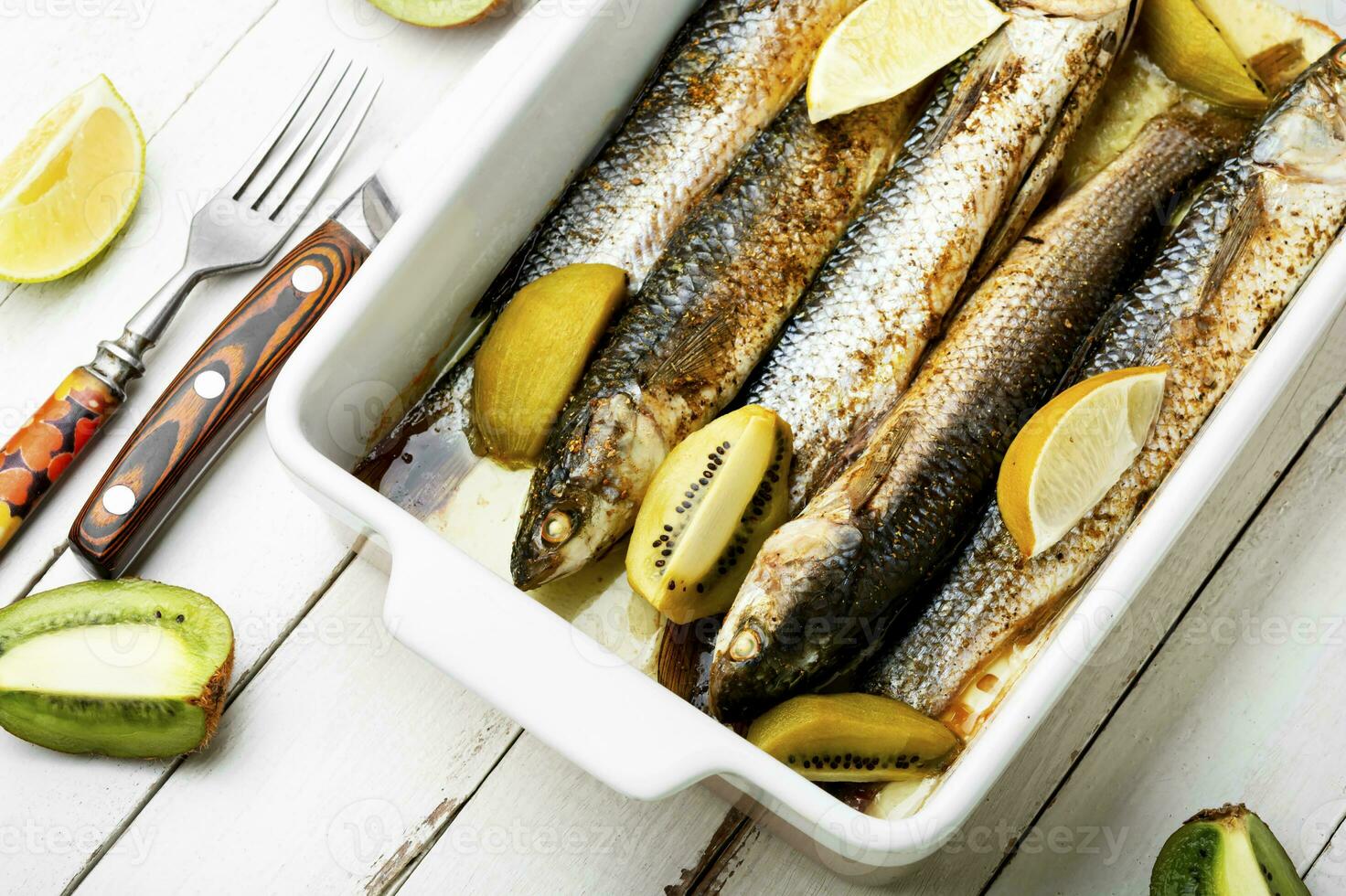 Baked whole fish with kiwi and lime. photo