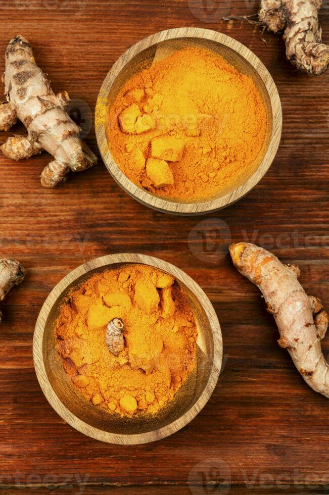 Turmeric root and turmeric powder. photo