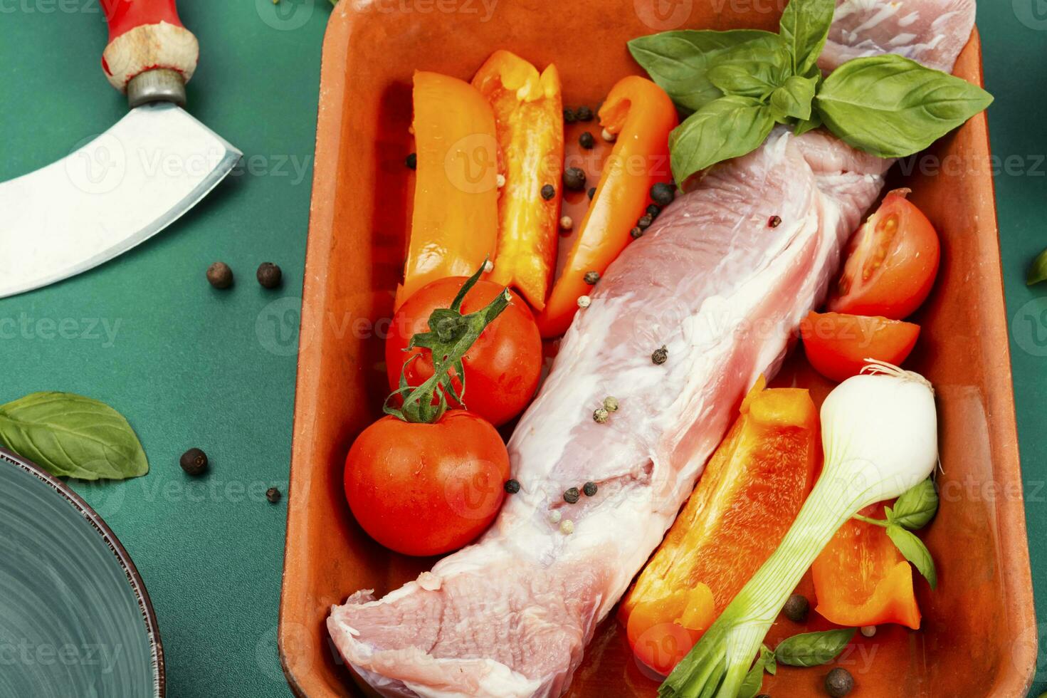 Raw pork tenderloin in a baking dish. photo