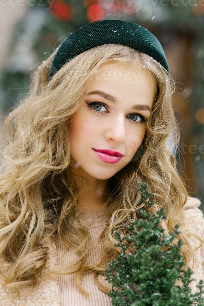 Portrait of a young beautiful woman with professional makeup, turquoise velvet hoop in her hair photo