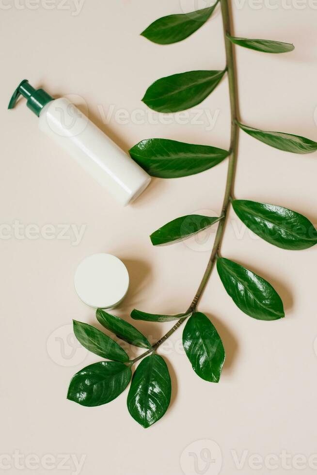 Natural home cosmetics in recyclable plastic bottles and cans on a beige background. Flat lay photo