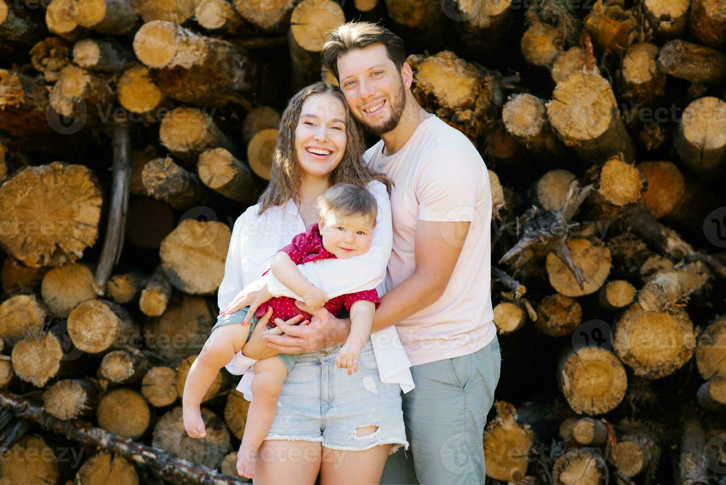 Dad, mom and baby son have fun in the fresh air. A happy family spends happy moments of their life photo